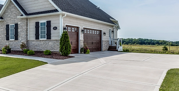 A clean residential exterior and driveway after outdoor cleaning